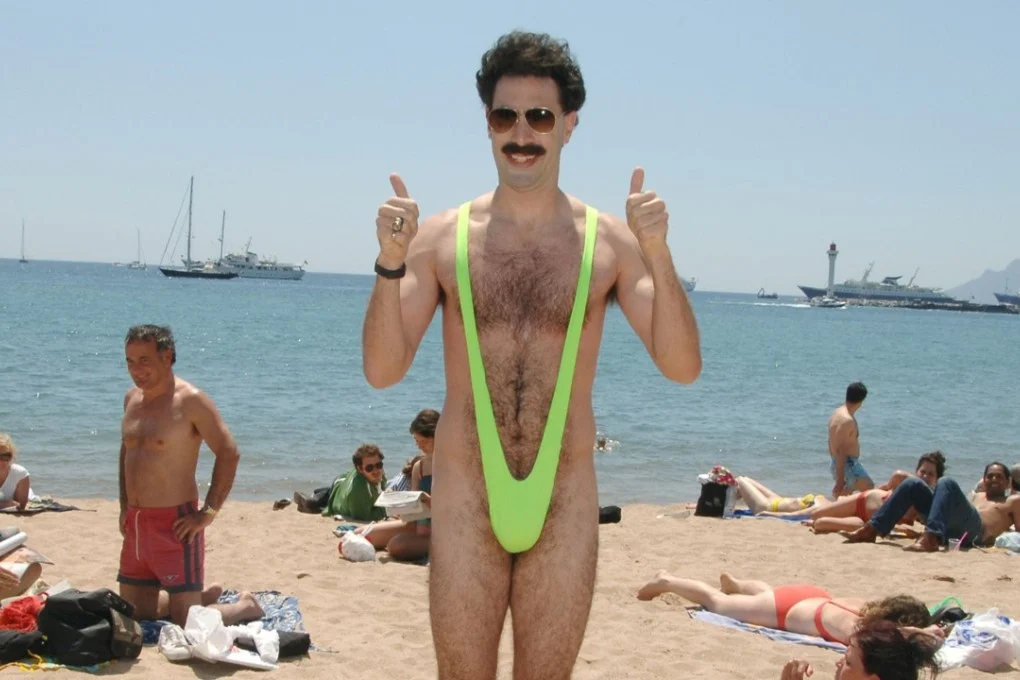 Borat in Banana Hammock on Beach - Sacha Baron Cohen meme template variation