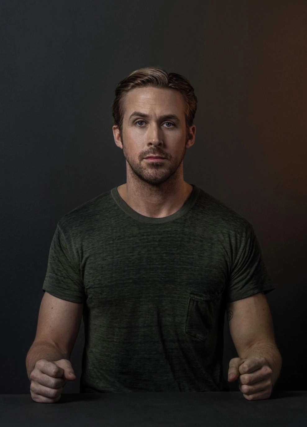 Ryan Gosling with Clenched Fists at Table meme template