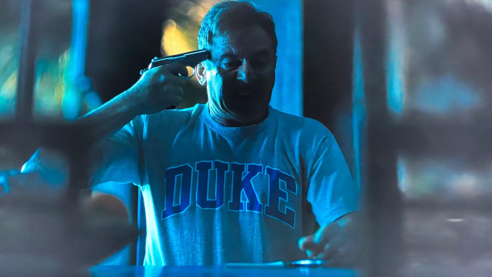 White Lotus dad with Duke shirt and gun meme template